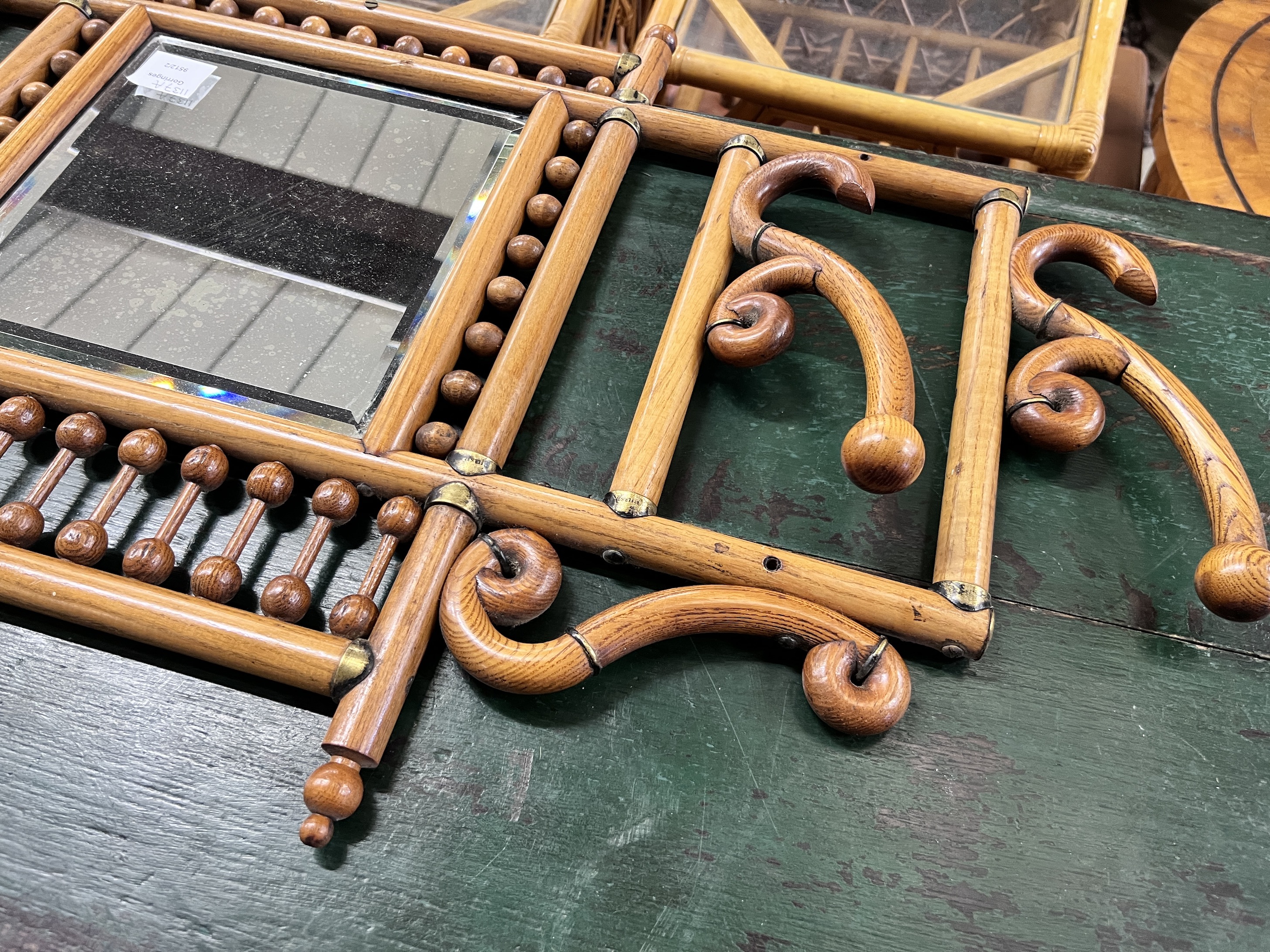 An early 20th century oak and beech mirrored wall hanging coat rack, width 84cm, height 52cm